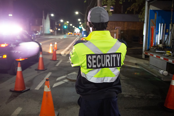 Security guard watching a construction site at night